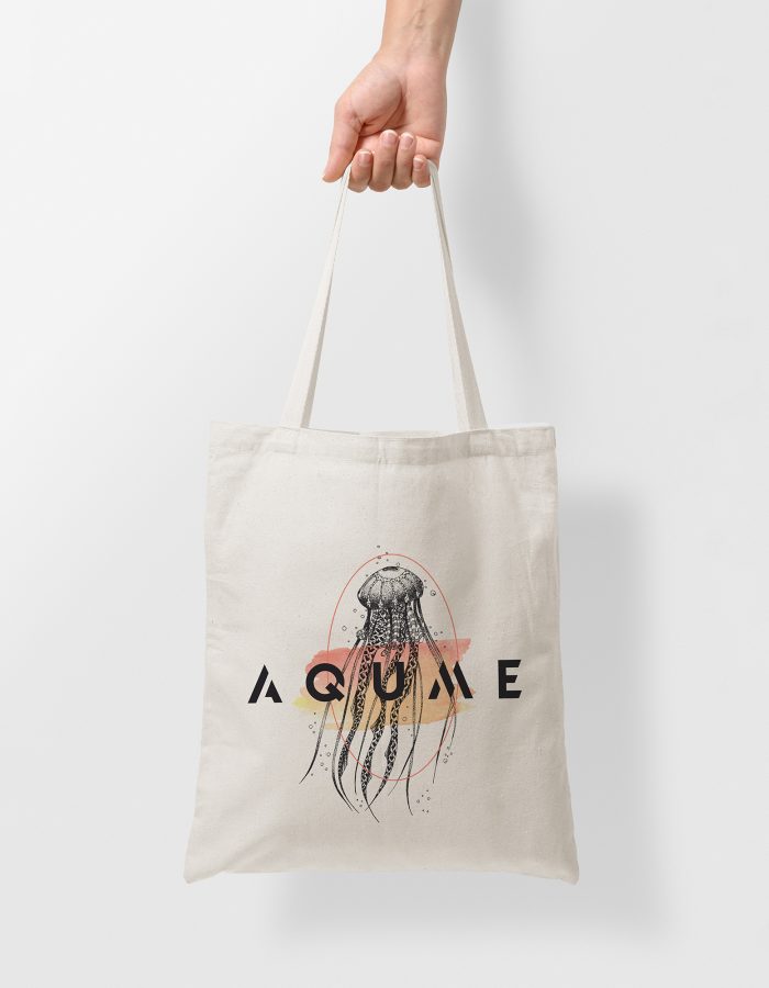 Mockup of female hand holding a blank Tote Canvas Bag on light g